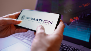 In this photo illustration, the Marathon Digital Holdings (MARA) logo is displayed on a smartphone screen