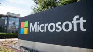 Wide-angle view of a Microsoft sign at the headquarters of a personal computer and cloud computing company, with an office building in the background.  MSFT Stocks