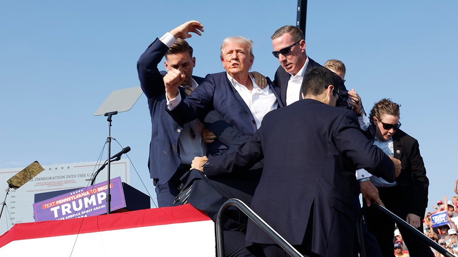 Donald Trump is rushed off stage during rally