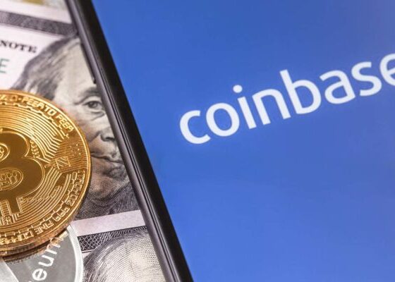 The Coinbase (COIN stock) logo on a smartphone screen with a BTC token. Crypto winter is setting in.