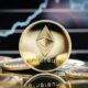 Ethereum cryptocurrency, physical coin close-up, in front of a price chart